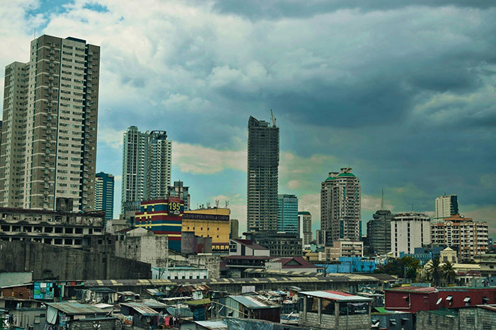 cityscape showing contrast between tall modern buildings and shanties below